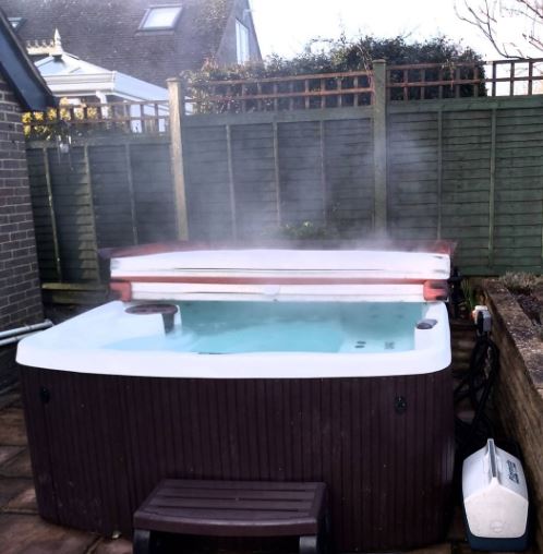 Steaming hot tub in a back garden